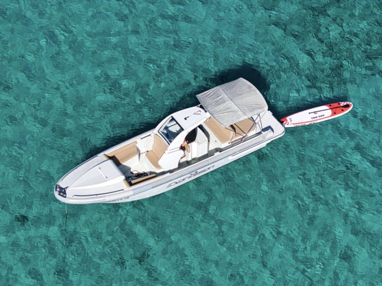 Aerial view of the boat with a SUP board floating alongside